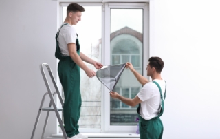 technicians apply window tint in home